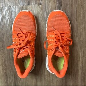 Nike Free run shoes in color orange, size 8. Sides and front are a little worn.